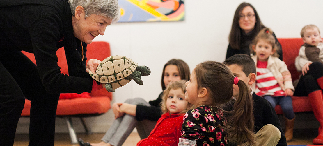 Lydia with turtle puppet at family concert